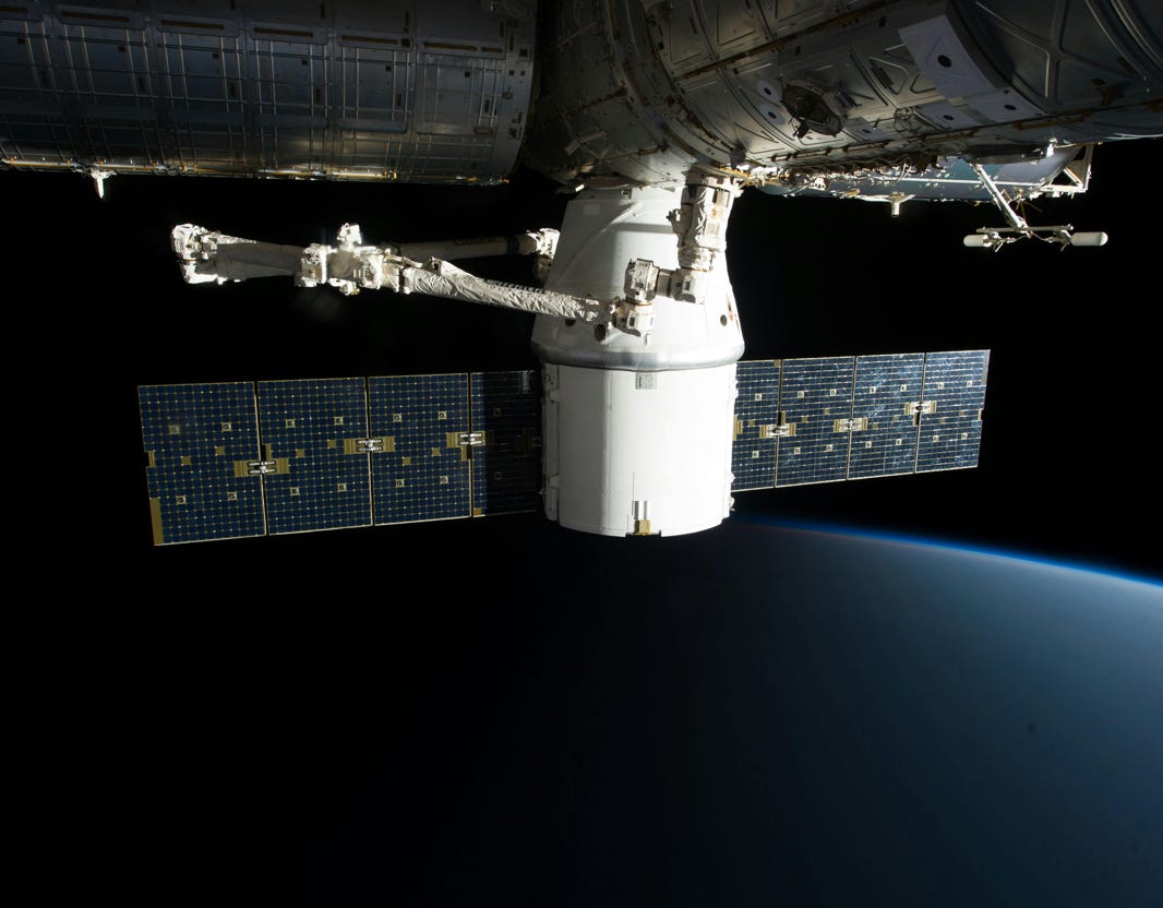 A SpaceX satellite hovering over Earth's horizon in outer space, showcasing advanced space technology.